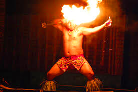 fire dancer performing with flaming props on stage